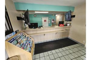 a waiting room with a cash counter in a store at Travel Inn By OYO Omaha in Millard