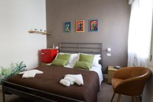 a bedroom with a bed with two towels on it at Fasthotel in Cervia