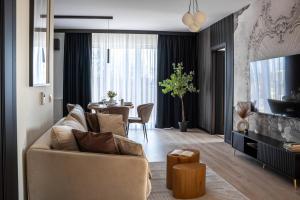 a living room with a couch and a table at Park Vista in Szczecinek