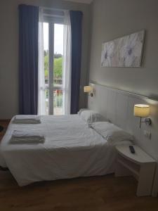 Postel nebo postele na pokoji v ubytování Lodges le Mura