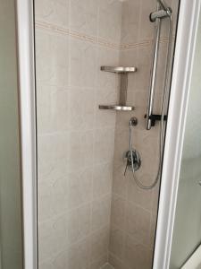 a bathroom with a shower with a glass door at casa di Ale e Bea in Dervio +16 photos