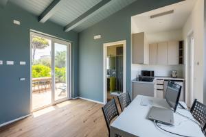 a kitchen with a table with a laptop on it at Sweet Sicily Apartments in Carini