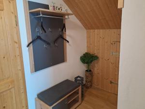 a room with wooden walls and a shelf with hangers at Ferienwohnung Richter in Peiting