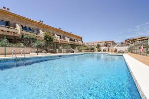 a large swimming pool in front of a building at Refreshing Oasis in El Médano