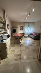 a kitchen and living room with a table in it at Gardalba in Toscolano Maderno +20 photos
