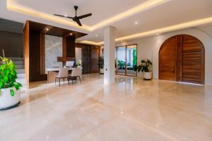 a living room with a ceiling fan and a dining room at Campbar 4 by AGATA in Canggu