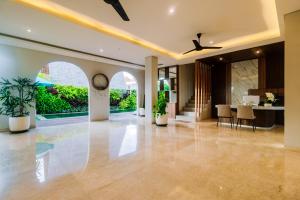 an open lobby with a dining area and a ceiling fan at Campbar 4 by AGATA in Canggu