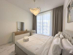 a white bedroom with a large bed and a window at Al Hamra Village Marina Residences in Ras al Khaimah +87 photos