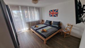 a bedroom with a bed with a flag on the wall at Ferienwohnung Wiesental 89331 Burgau, Wiesentalstrasse 1 in Burgau