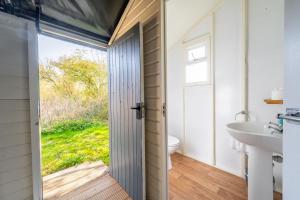 a bathroom with a toilet and a sink at Swift - Sweffling Hall in Rendham +25 photos