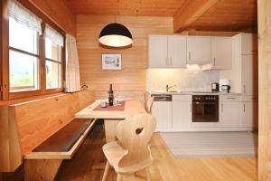 a kitchen with white cabinets and a table and a window at Haus Albrecht in Schoppernau +11 photos