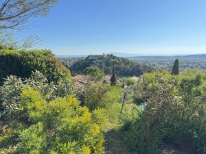 a view of a hill with bushes and trees at Villa Notre-Dame avec piscine in Rochefort-du-Gard