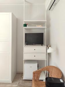 a white desk with a television in a room at Colleoni 19 in Civitanova Marche