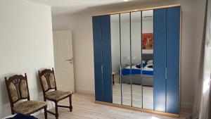 a room with a large glass door with two chairs at Ferienpark Worpswede in Worpswede