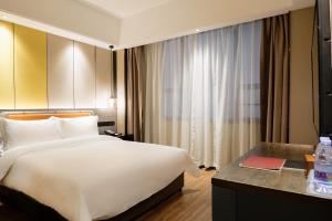 Postel nebo postele na pokoji v ubytování Paco Hotel Datang Metro Guangzhou-Close to Pazhou Exhibition Hall and free breakfast
