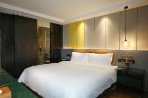 Postel nebo postele na pokoji v ubytování Paco Hotel Datang Metro Guangzhou-Close to Pazhou Exhibition Hall and free breakfast