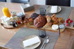 a table with a tray of bread and pastries on it at Anna et Jean-Paul in L'Isle-sur-la-Sorgue