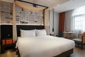 Postel nebo postele na pokoji v ubytování Paco Hotel Datang Metro Guangzhou-Close to Pazhou Exhibition Hall and free breakfast