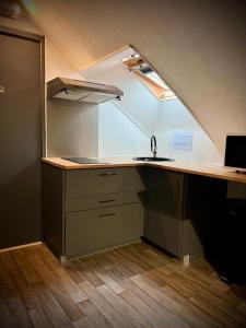 an attic kitchen with a sink and a counter at Le Beau Séjour 1 - Très Elégant - Proche Aéroport in Beauvais