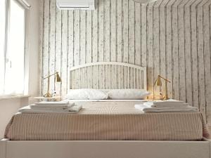a bedroom with a large bed with two towels on it at Colleoni 19 in Civitanova Marche