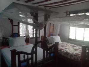 Postel nebo postele na pokoji v ubytování Magharibi House