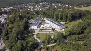 an aerial view of a large building in the forest at Schlosspark Mauerbach - Adults only in Mauerbach
