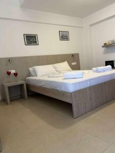a bedroom with a bed with two towels on it at ERA Studios2 in Skiathos +17 photos
