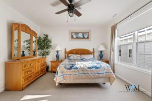a bedroom with a bed and a dresser and a window at Charming 3-Bedroom, 2-Bathroom Townhouse Perfectly Located Near the Boardwalk in Ocean City