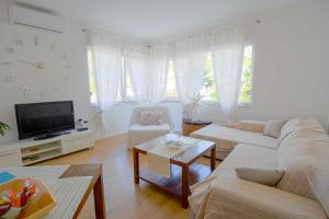 salon z kanapą i telewizorem w obiekcie Deluxe Apartments Goya w mieście Zadar