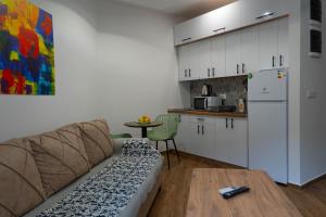 a living room with a couch and a kitchen at Urban Stay - Main Area Apartments in Skopje +12 photos