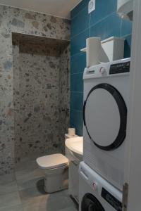a bathroom with a toilet and a mirror on the wall at Urban Stay - Main Area Apartments in Skopje