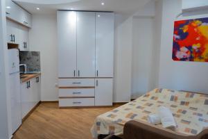 a small bedroom with a bed and a kitchen at Urban Stay - Main Area Apartments in Skopje