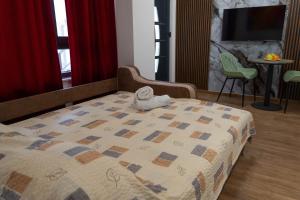 a bedroom with a bed with a stuffed animal on it at Urban Stay - Main Area Apartments in Skopje