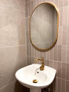 a bathroom with a sink and a mirror at IKO homes in Kota Kinabalu