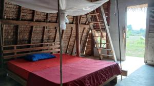 a bedroom with a canopy bed with a ladder at Eco Lotus Kampot in Kampot