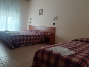 Postel nebo postele na pokoji v ubytování Hotel Sirios