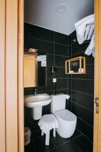 a bathroom with a white sink and a toilet at Hotel Zaragoza Plaza in Donostia-San Sebastián