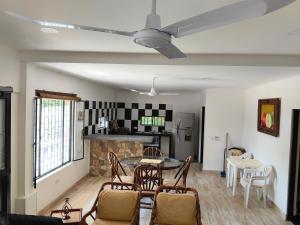 a living room with a table and chairs at Villa Stefy in Carmen de Apicalá