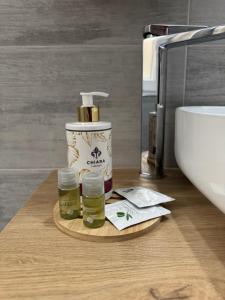 a bathroom counter with a bottle of essential oils and a sink at Edward House in La Spezia +22 photos