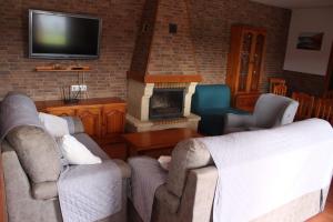 a living room with two couches and a fireplace at Matilde&Leire in Barbate