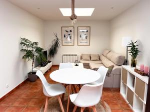 a living room with a white table and chairs at Casa MAR DE GAIA Corcubión in Corcubión