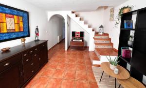 a hallway with a staircase and a living room at Casa MAR DE GAIA Corcubión in Corcubión