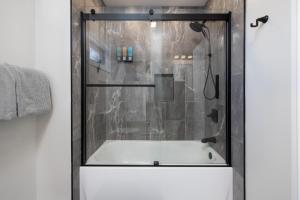 a shower with a white tub in a bathroom at Lakefront Luxury At Stony Pointe in Ballston Spa +44 photos