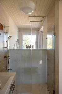 a bathroom with a shower and a glass shower stall at Belavista Villages in Riba Douro