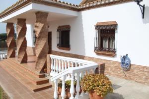 a white house with a staircase and windows at Matilde&Leire in Barbate
