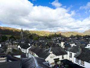 a town with houses and mountains in the background at Lanty Scar - Amazing Views! in Ambleside