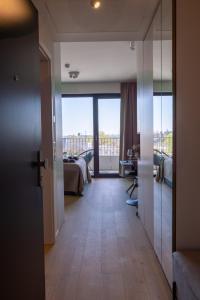 einen Flur mit einem Zimmer mit einem Bett und einem Balkon in der Unterkunft Apartmán LEON - FREE GARAGE PARKING in Bratislava