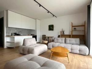 a living room with two couches and a table at On the Edge - Suites & Apartments in Aridaia