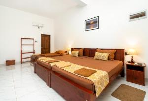 Postel nebo postele na pokoji v ubytování Mailagama Cinnamon Residence