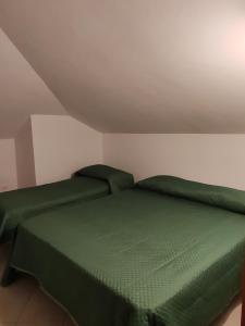 a bedroom with a green bed in a room at Belo Horizonte Loft in Montesilvano +3 photos